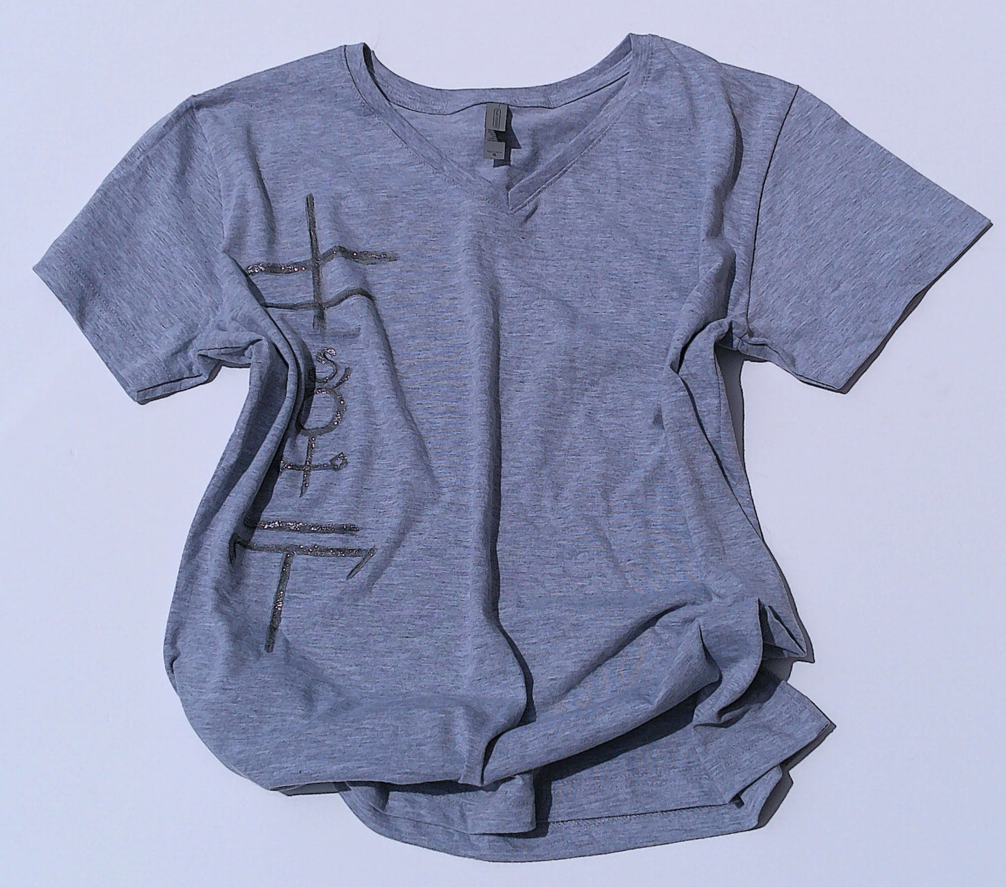 Gray t-shirt with occult symbols design on a light blue background