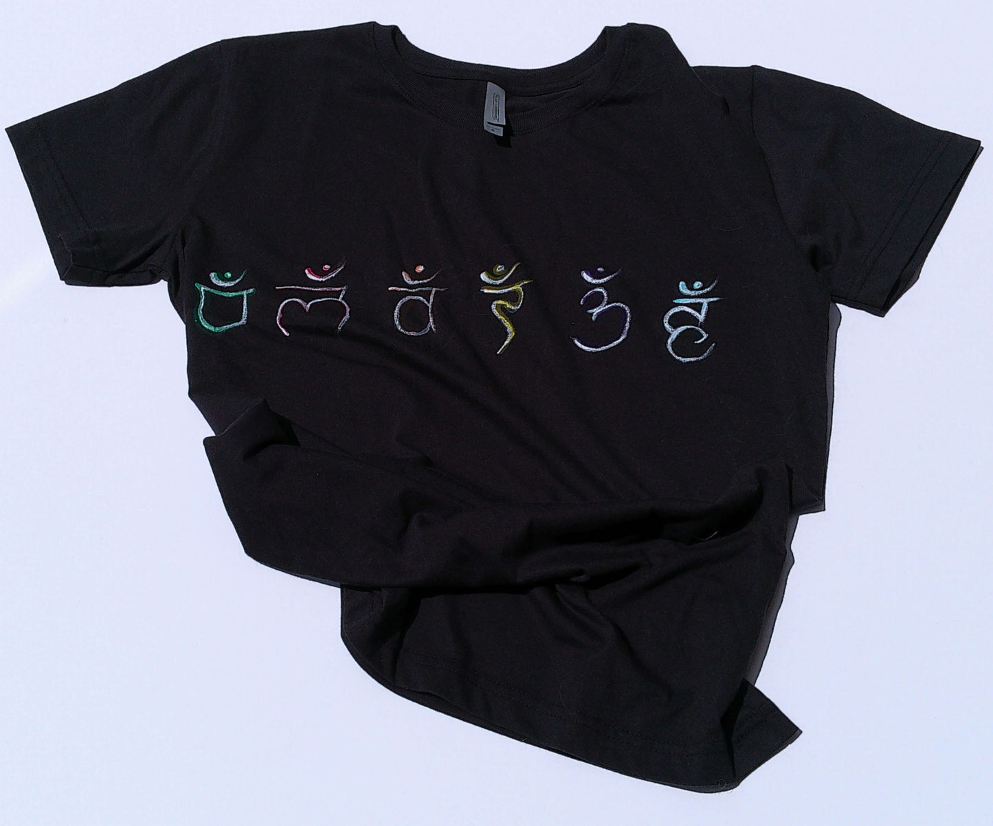 Black t-shirt with colorful symbols on a light blue background