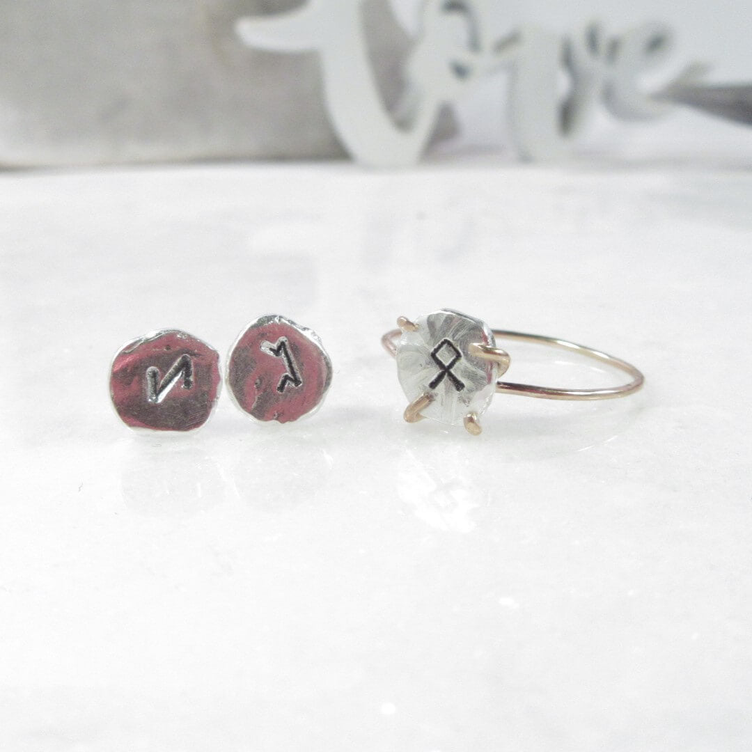 A pair of silver nugget post earrings and a rune ring in silver and gold