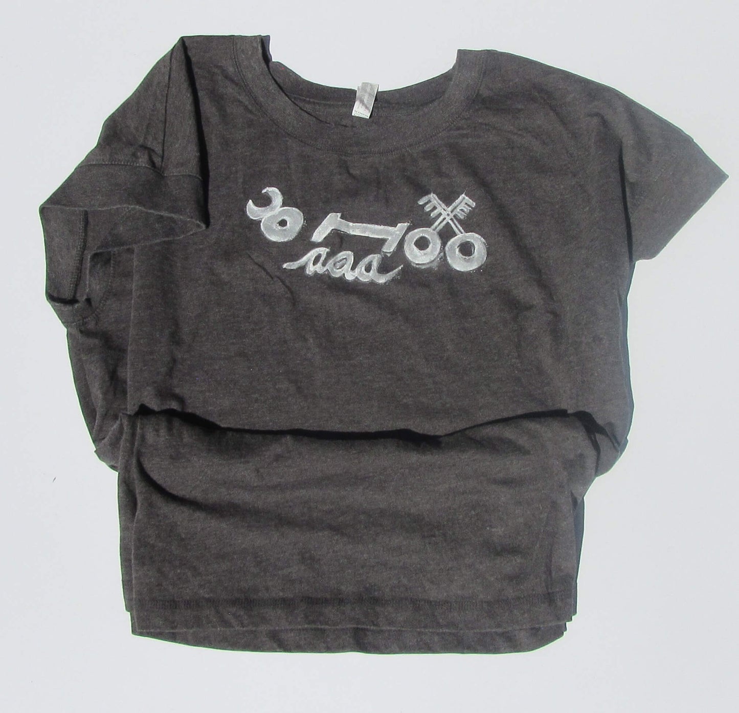 Gray t-shirt with white graphic design on a light gray background