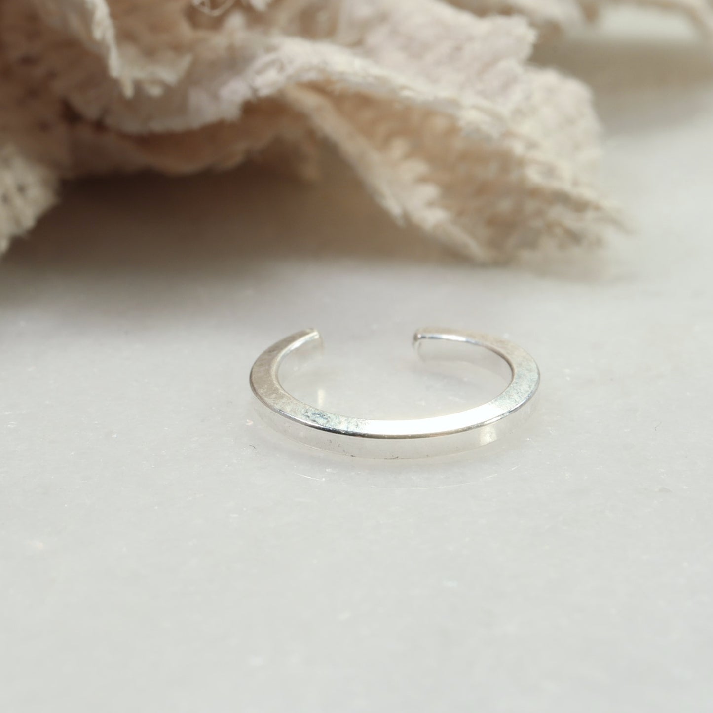 Silver ring on a light background with a soft focus