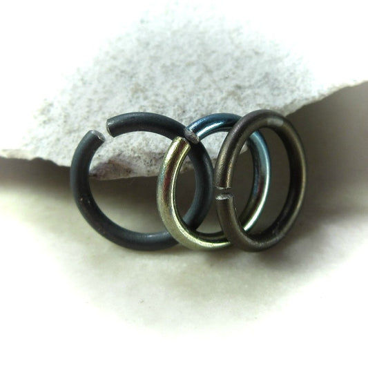Black, rainbow and bronze septum rings