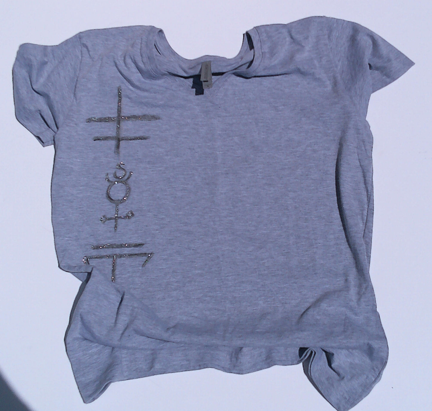 Gray t-shirt with symbols on a light blue background