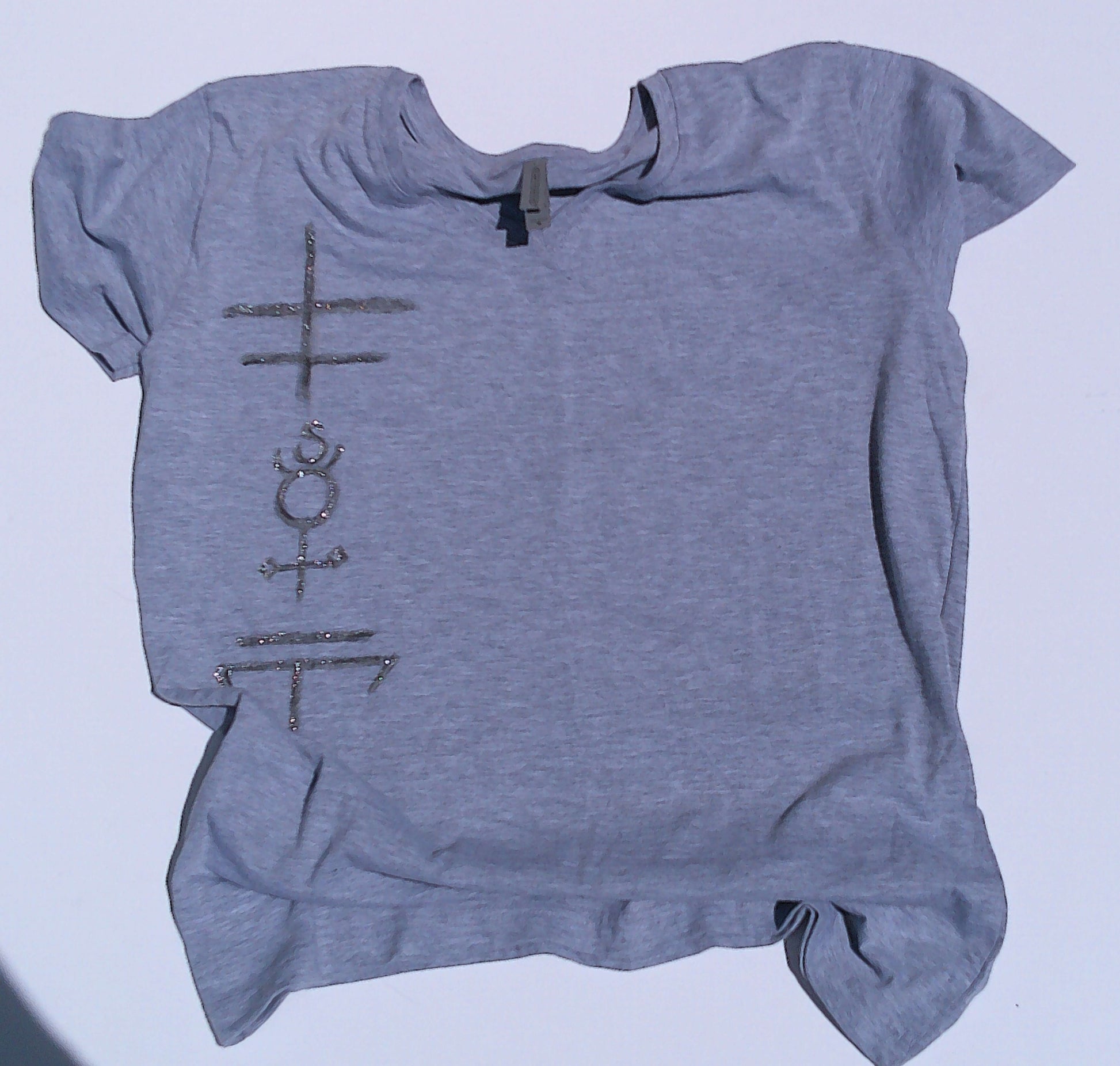 Gray t-shirt with symbols on a light blue background