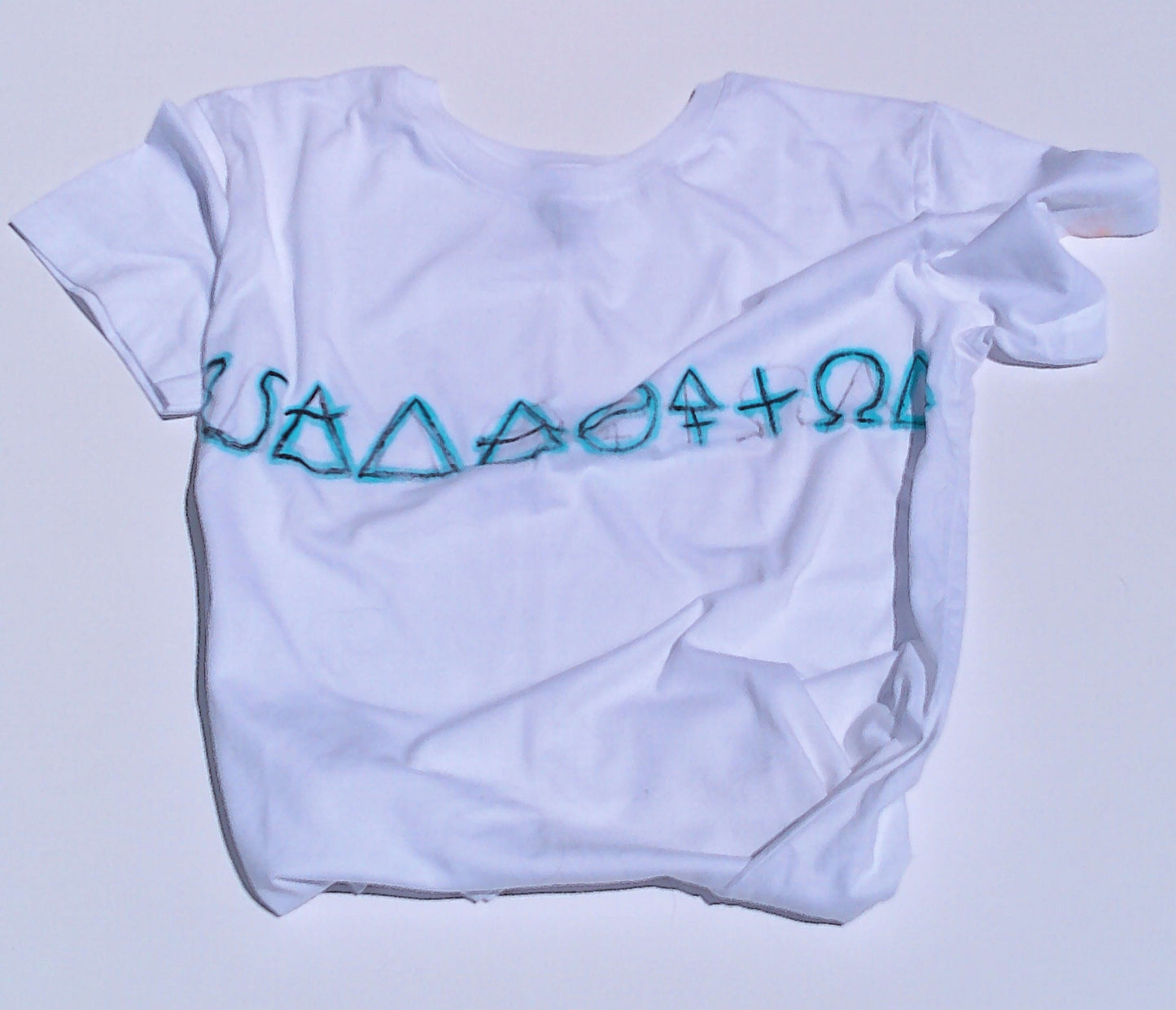 White t-shirt with blue symbols on a light gray background
