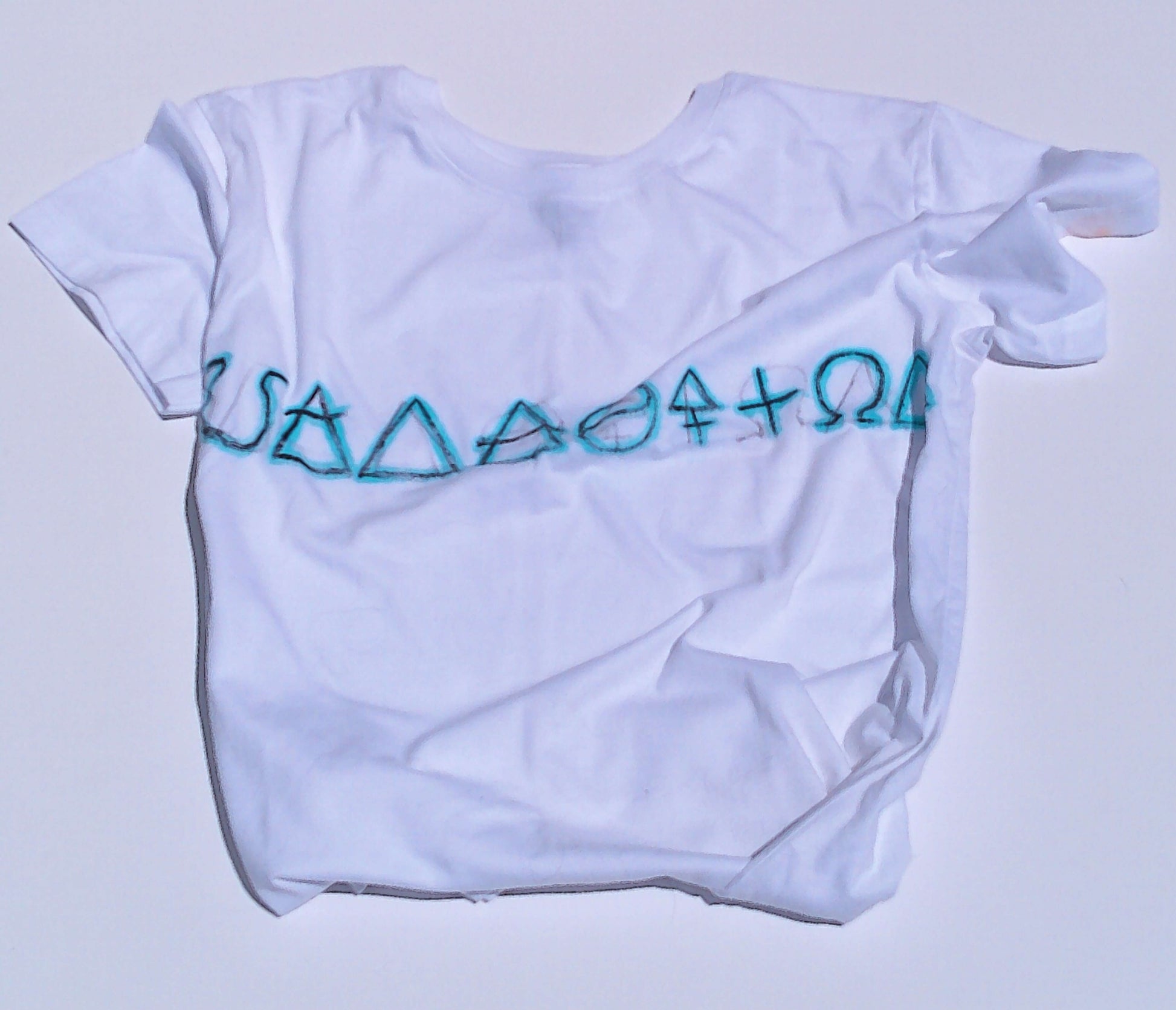 White t-shirt with blue symbols on a light gray background