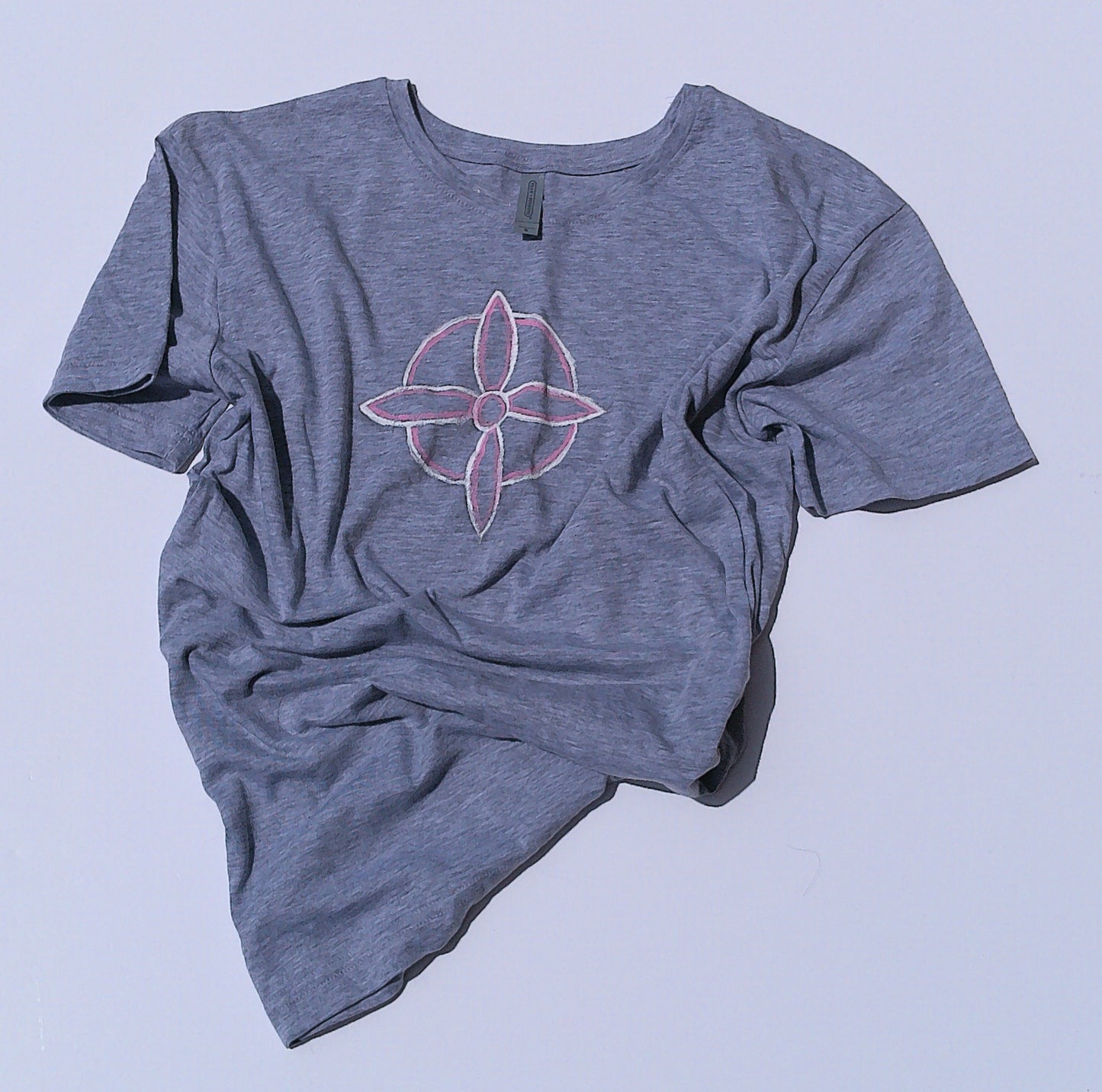 Gray t-shirt with a witches knot design on a light gray background