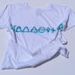 White t-shirt with blue geometric design on a light gray background