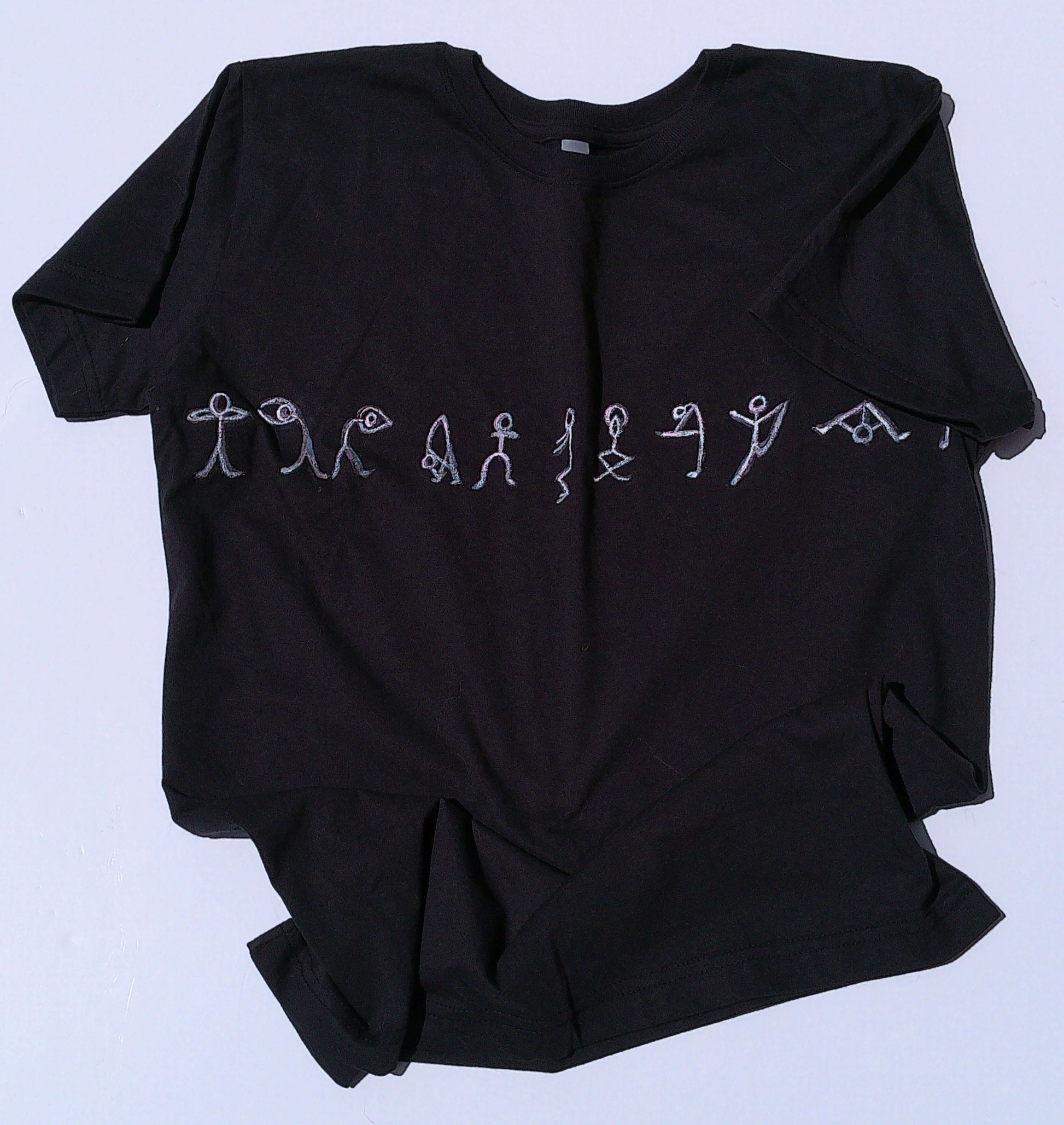 Black t shirt with white yoga designs on a light gray background