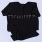 Black t-shirt with white yoga design on a light blue background