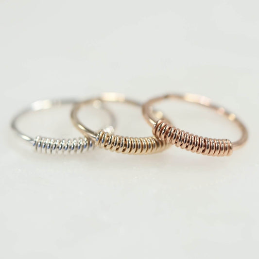 three hoop earrings, silver, gold, pink gold on white background