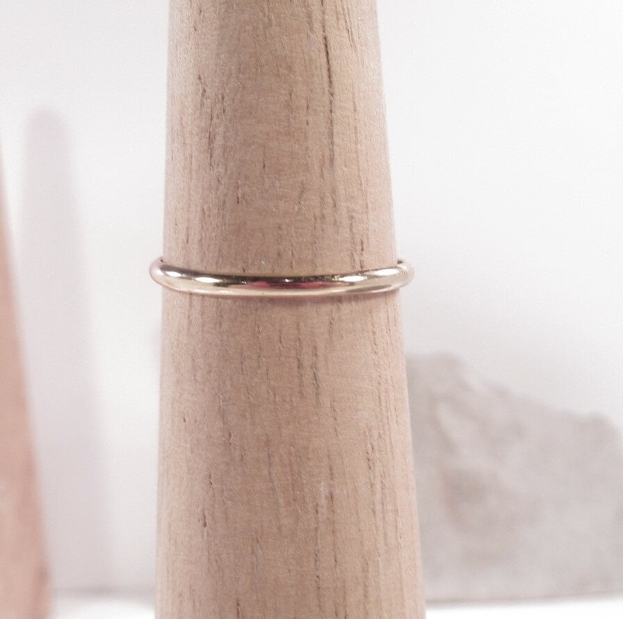 thin band gold ring on mandrel