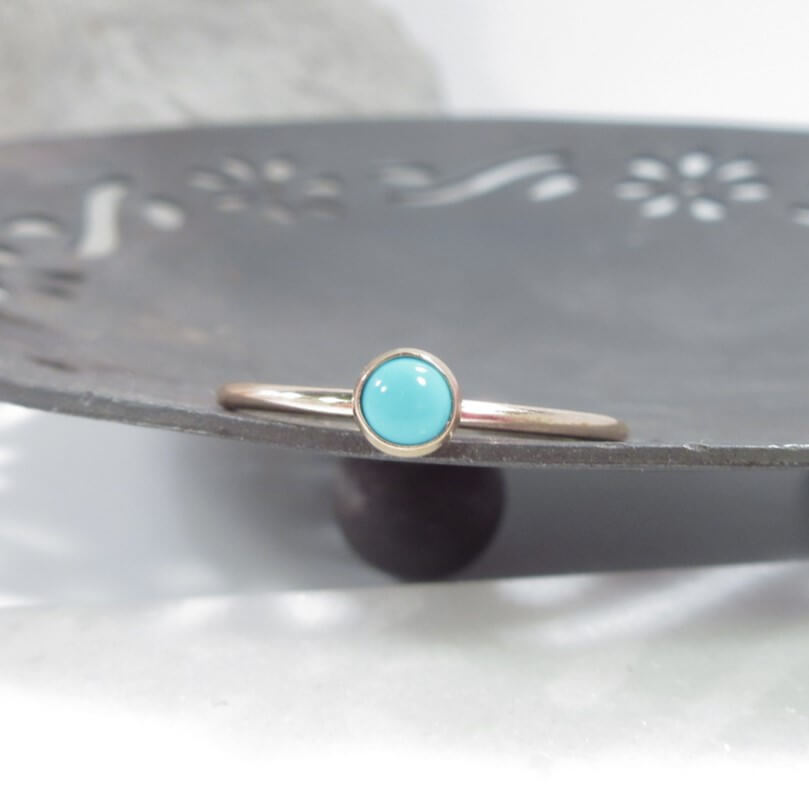 turquoise in yellow gold ring on dish 