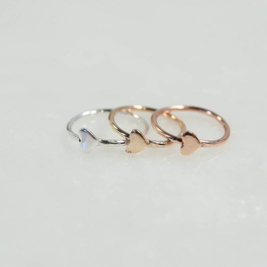 three hoop earrings silver, gold and pink gold with a heart on a white background