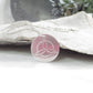 Symbol pendant with a Celtic knot design on a white surface