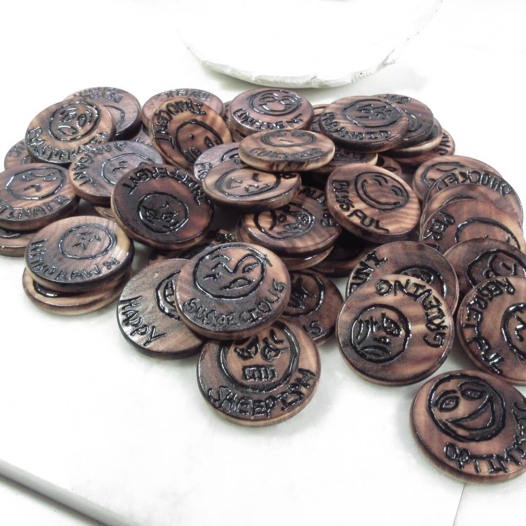 Collection of tokens with embossed text on a white background