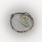 Beaded pendulum with a Saint Christopher charm on a white background