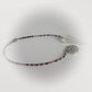 Multicolored beaded pendulum with a silver cross pendant on a white background