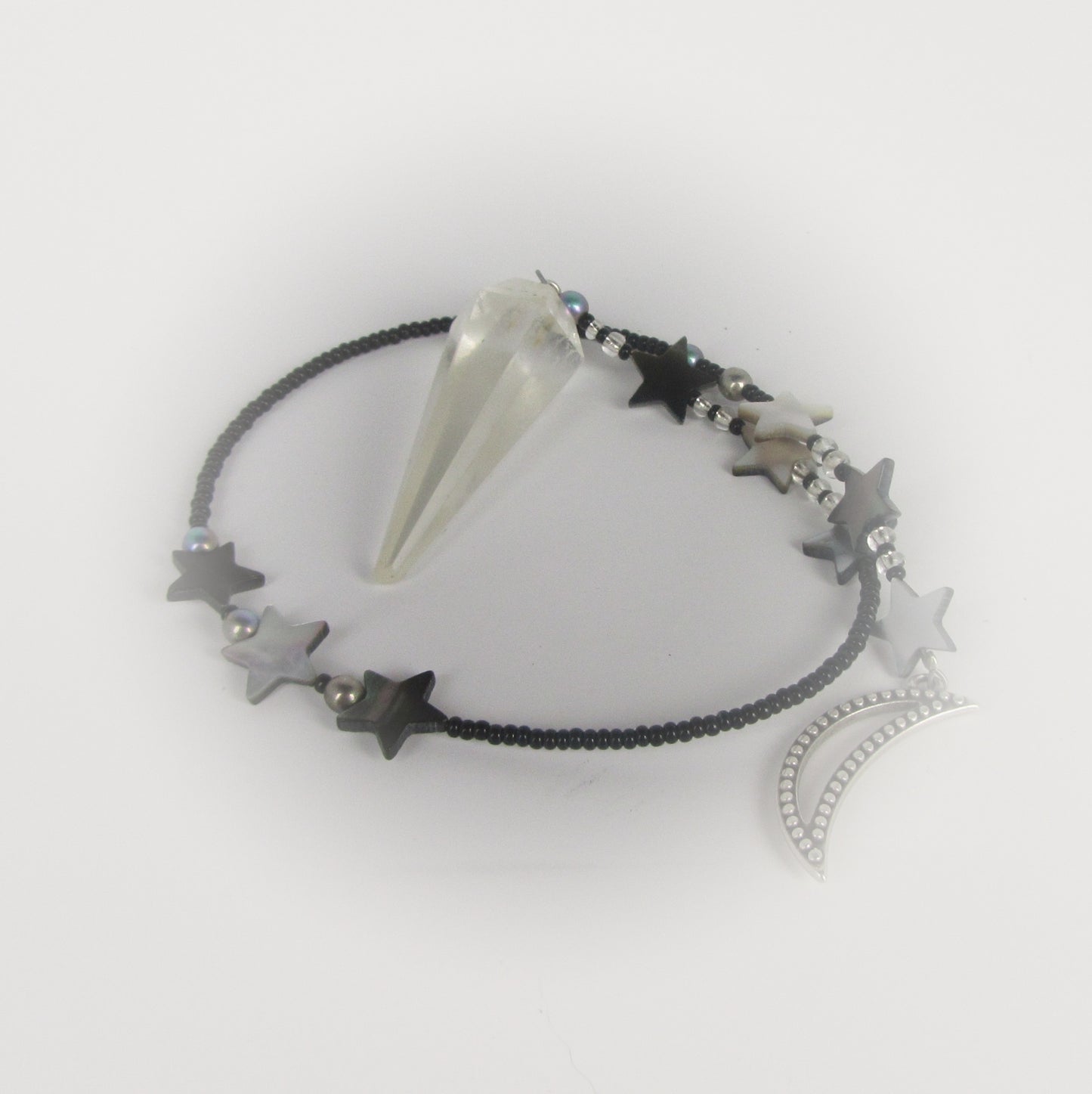 quartz crystal pendulum on white background