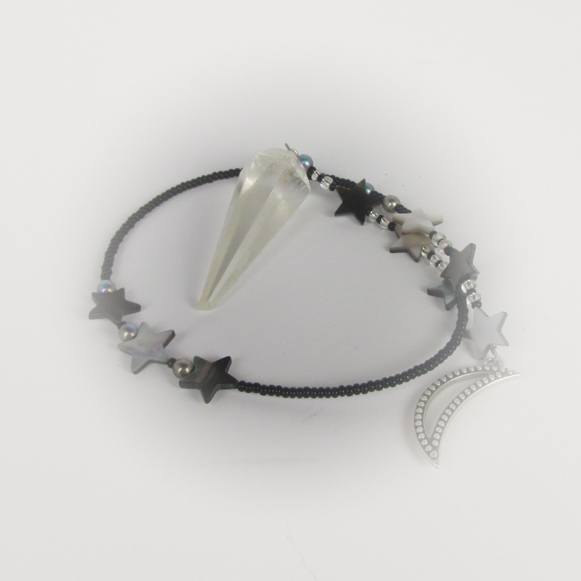 quartz crystal pendulum on white background