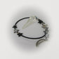 Pendulum with star-shaped beads and a clear crystal on a white background