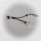 Beaded pendulum with an ankh charm on a white background