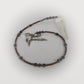 Beaded pendulum with a hummingbird charm on a white background