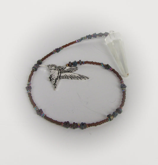 Beaded pendulum with a hummingbird charm on a white background