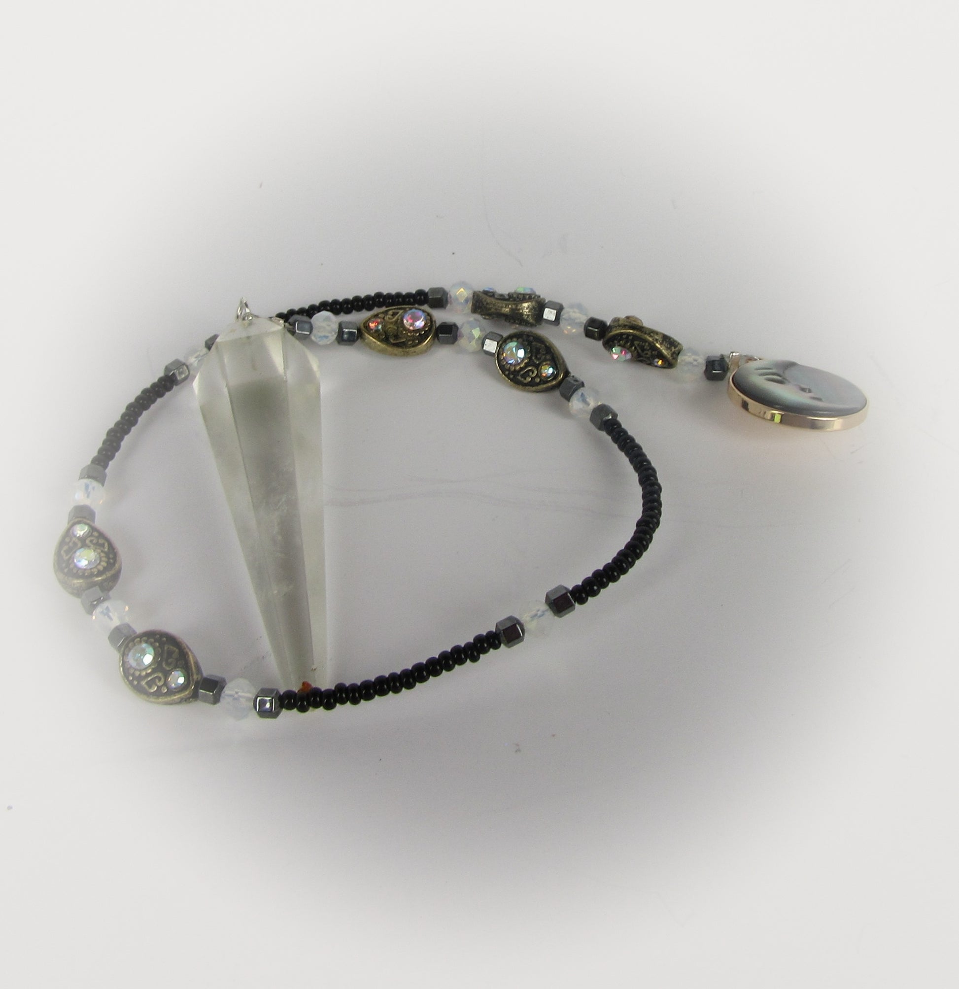 Pendulum with a man on the moon pendant on a white background