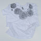 White t-shirt with black floral designs on a white background
