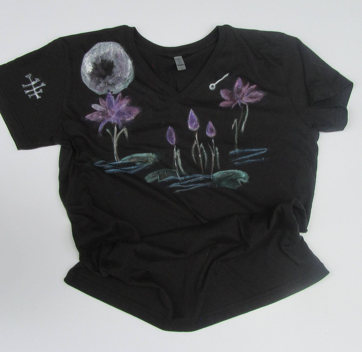 Black t-shirt with floral designs on a white background