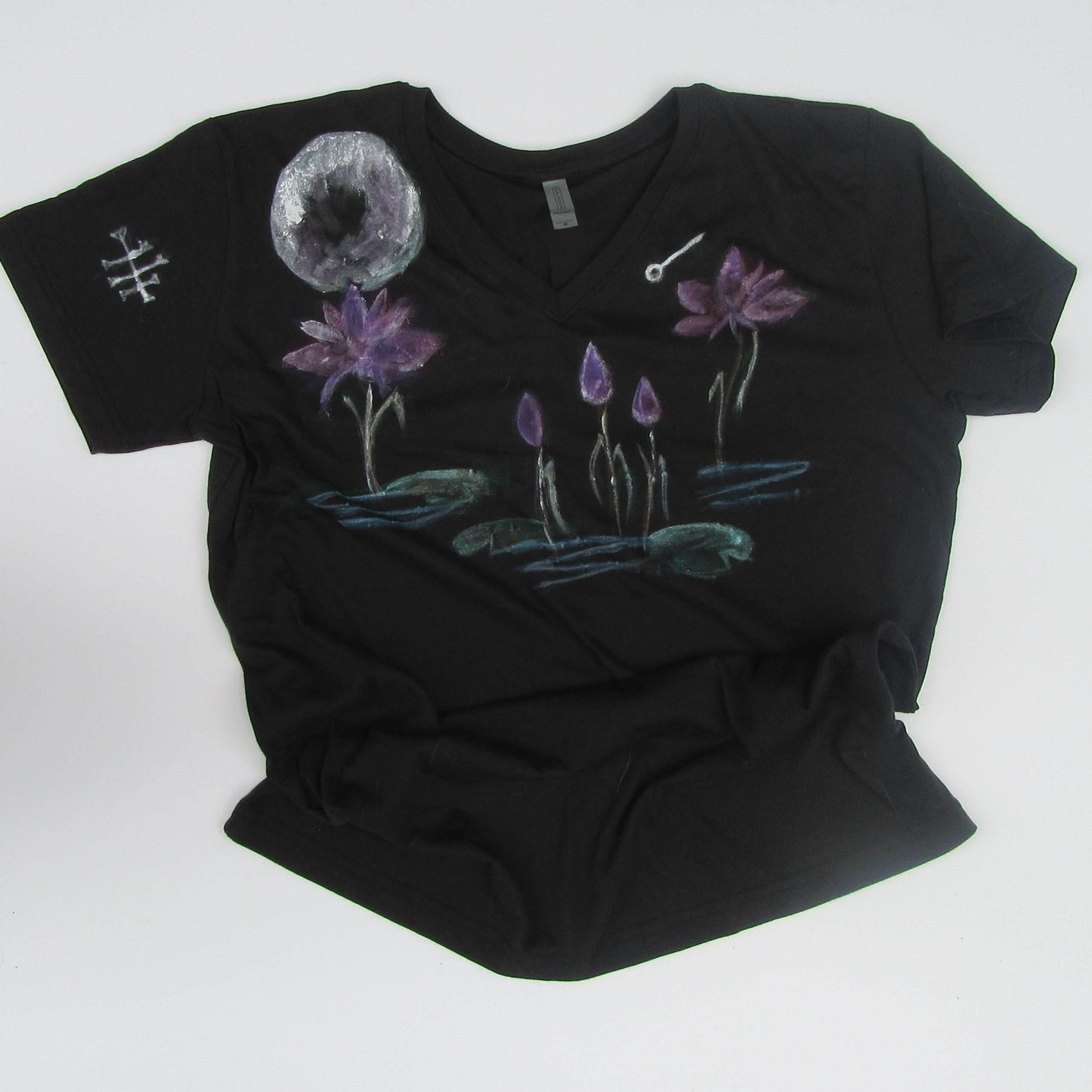 Black t-shirt with hand-painted purple flowers and a moon on a white background