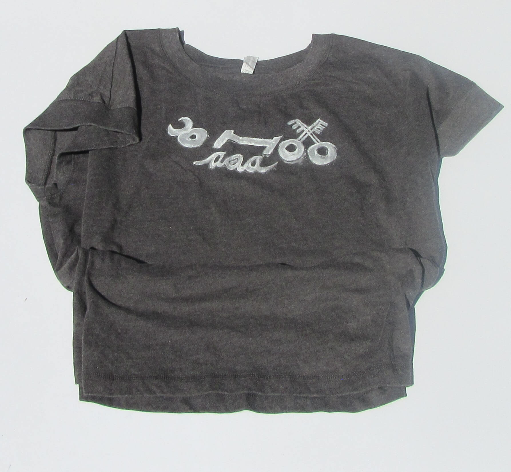 Gray t-shirt with white graphic design on a light gray background