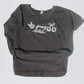 Gray t-shirt with white graphic design on a light gray background