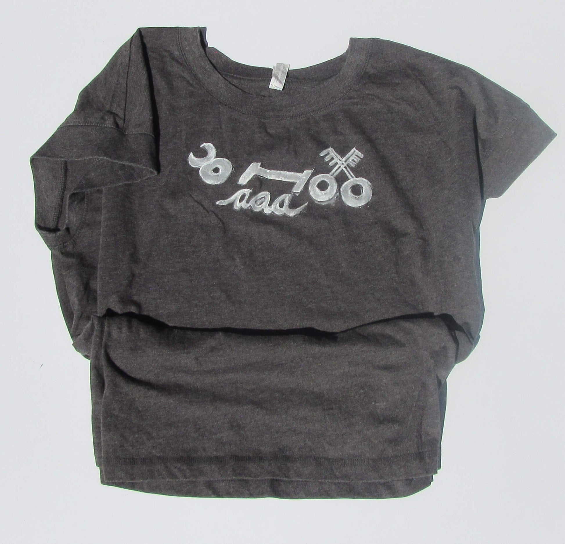 Gray t-shirt with white graphic design on a light gray background