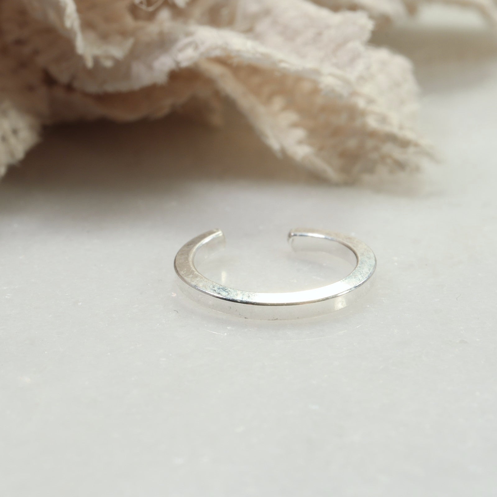 Silver ring on a light background with a soft focus