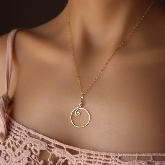 gold charm holder necklace on model 
