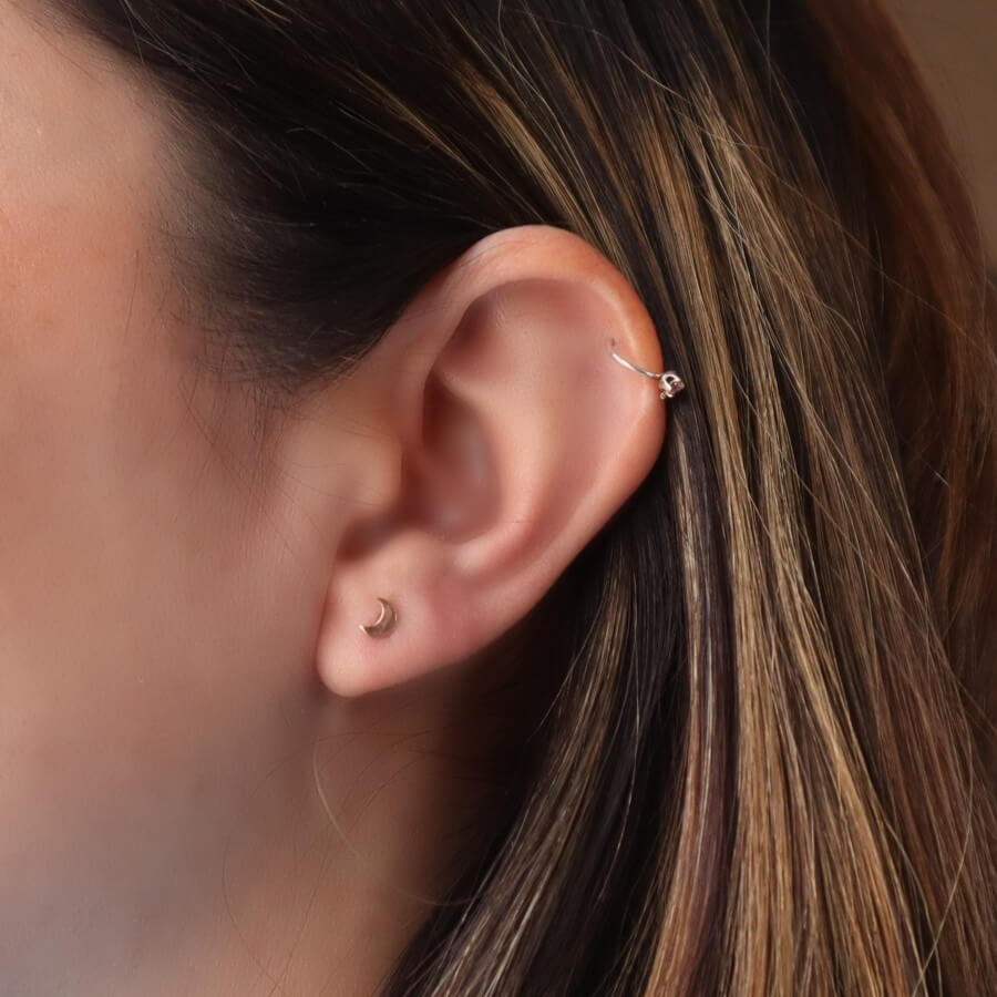 model wearing crescent moon post earrings