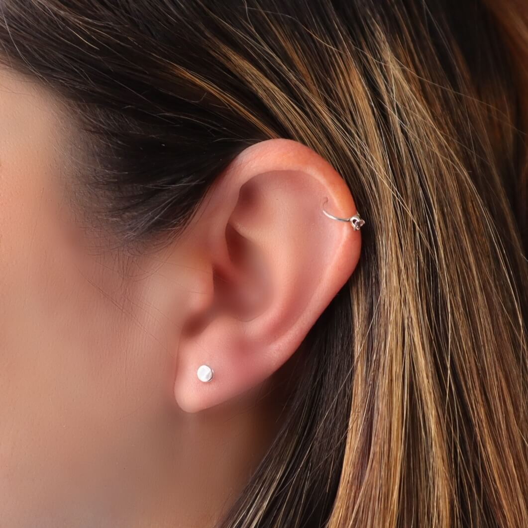 model wearing 2.5mm dot post earring