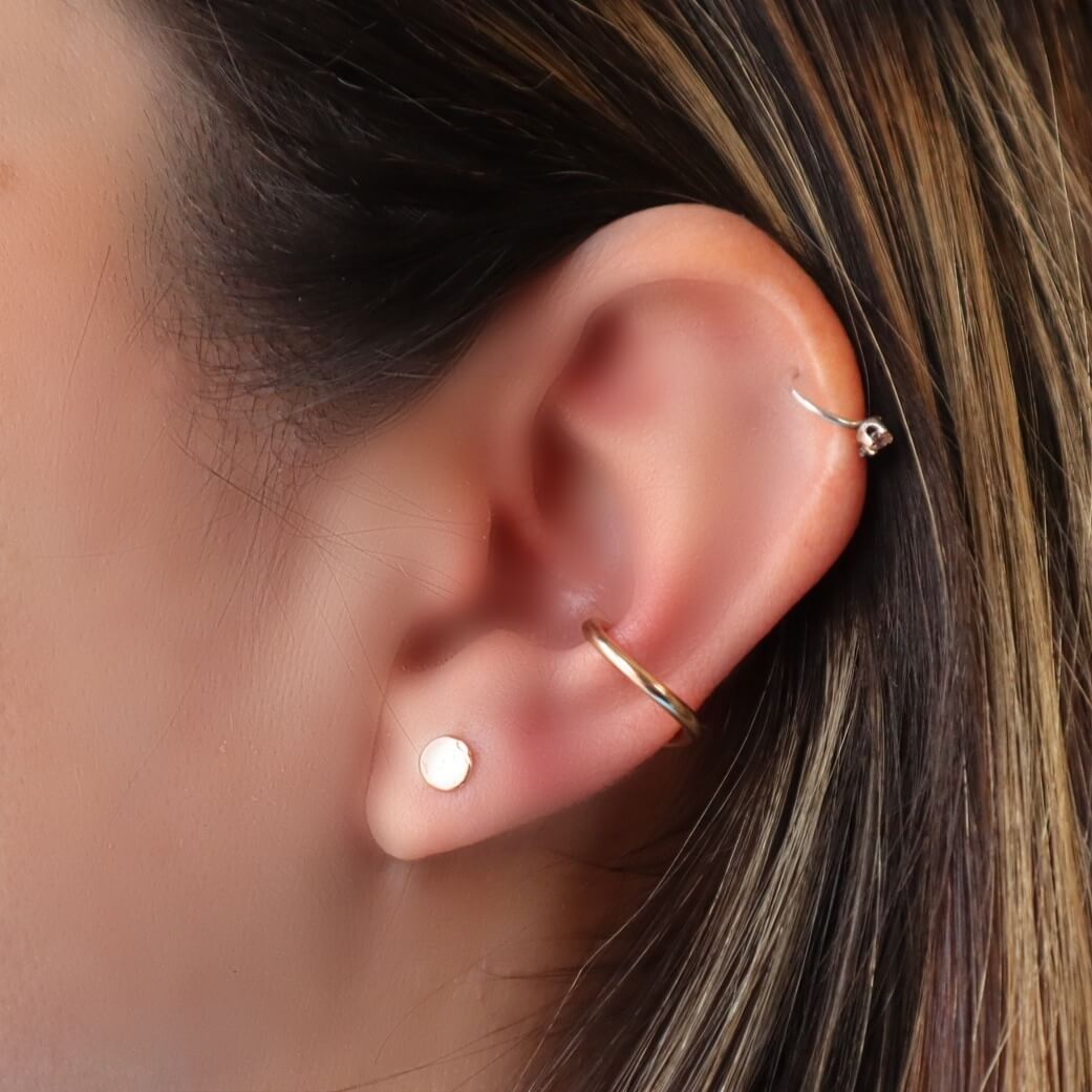 model wearing dot post earrings in gold