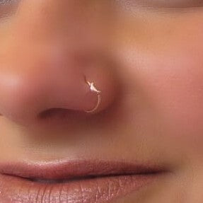 model wearing gold crescent moon nose ring