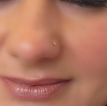 model wearing gold star nose stud